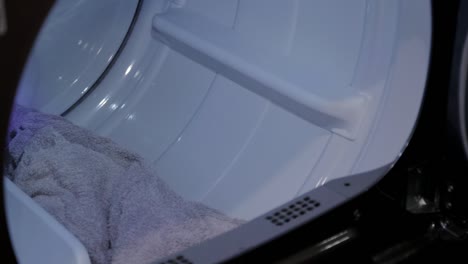 towels being pulled out of a dryer