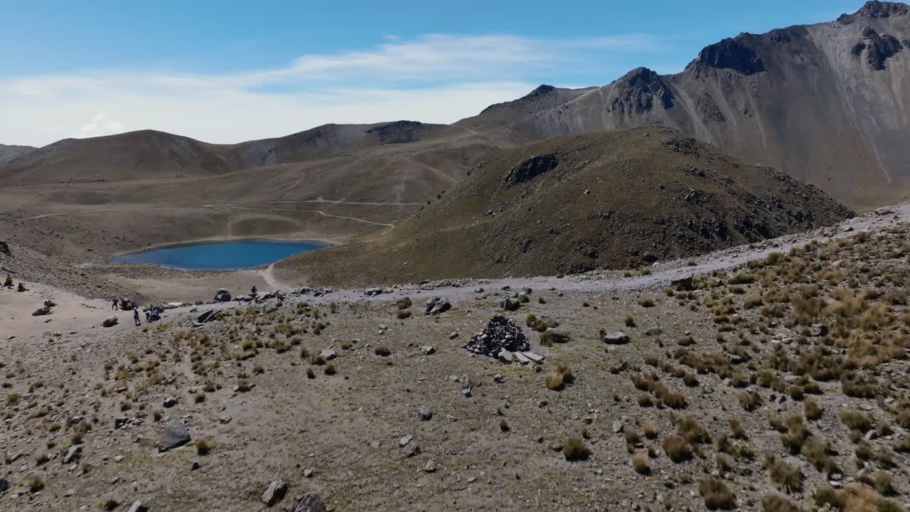 Aerial establishing shot of Laguna del la Luna inside volcano crater. Sunny day in summer showing spectacular mountain landscape of Mexico National park. Wide shot.