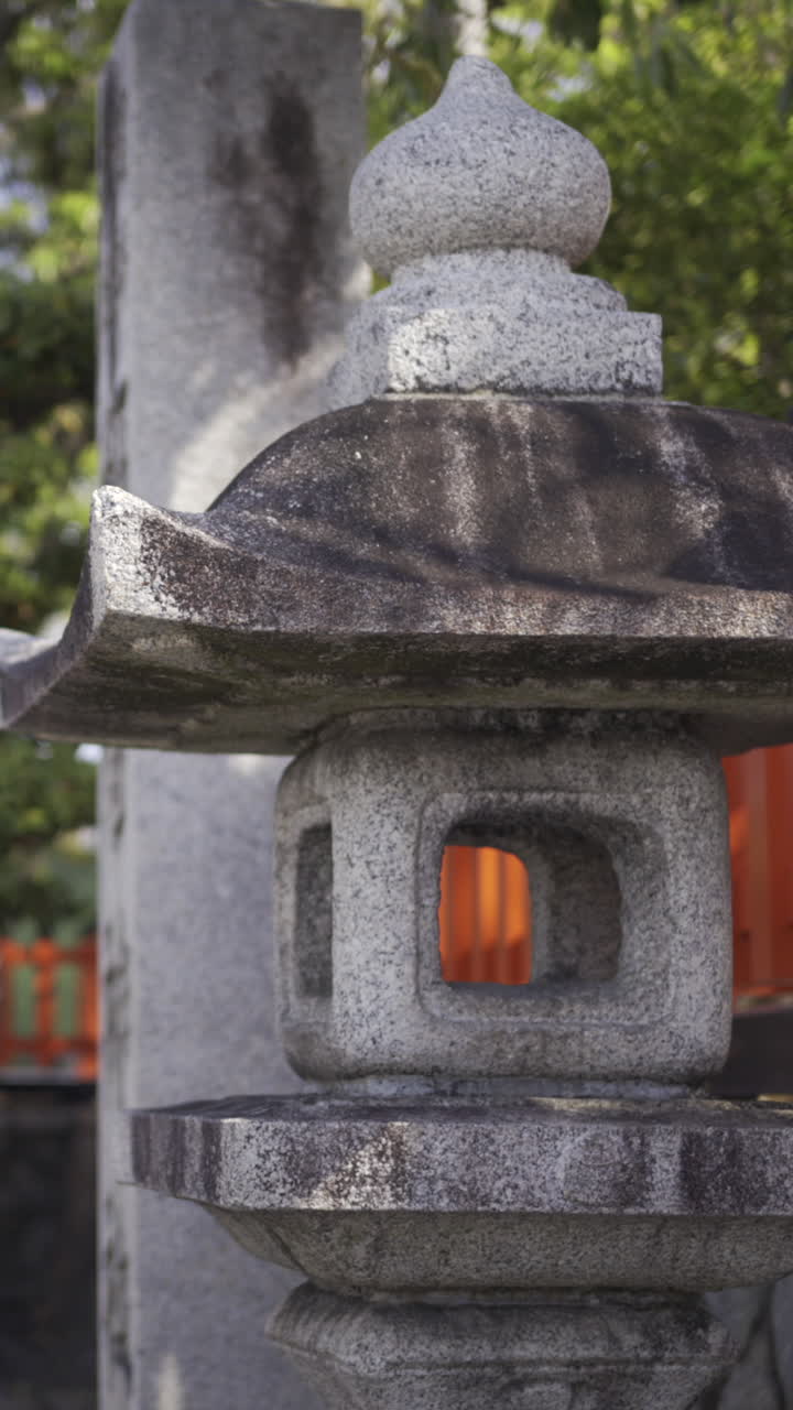 Exploring a serene garden with traditional stone lanterns under a clear sky in a peaceful location