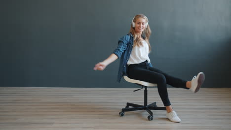 woman enjoying music on a chair