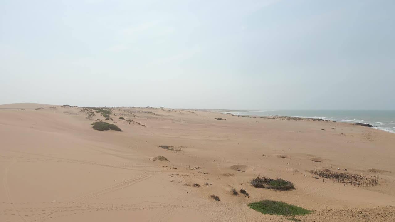 Drone establishing over empty sands of Guajira desert, emphasizing endless sandy terrain and remote wilderness