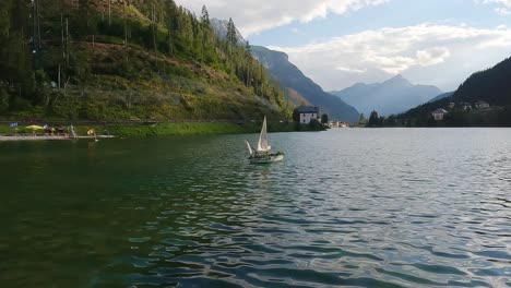 decorative boat floating on lake alleghe in the italian alps on a beautiful summer day