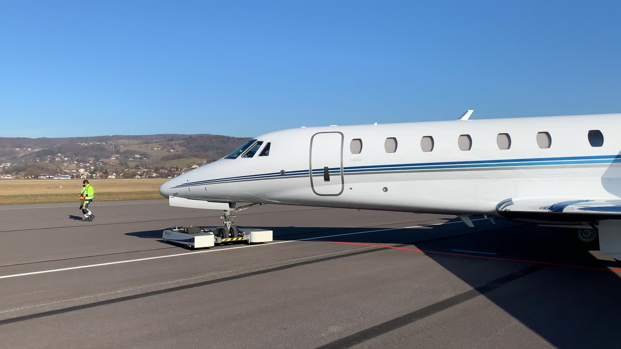 Private Jet on Airport Tarmac with Ground Crew