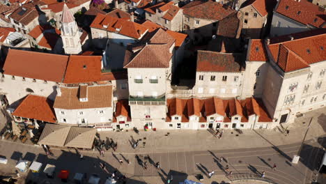 vista aérea de la gente caminando en el paseo marítimo con arquitectura veneciana en el casco antiguo de trogir en croacia en verano