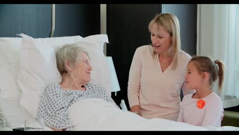 Family-Visit-To-Grandmother-In-Hospital-Bed