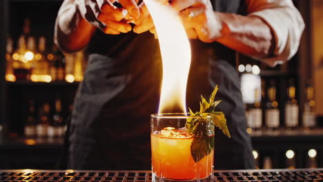 bartender flaming a cocktail