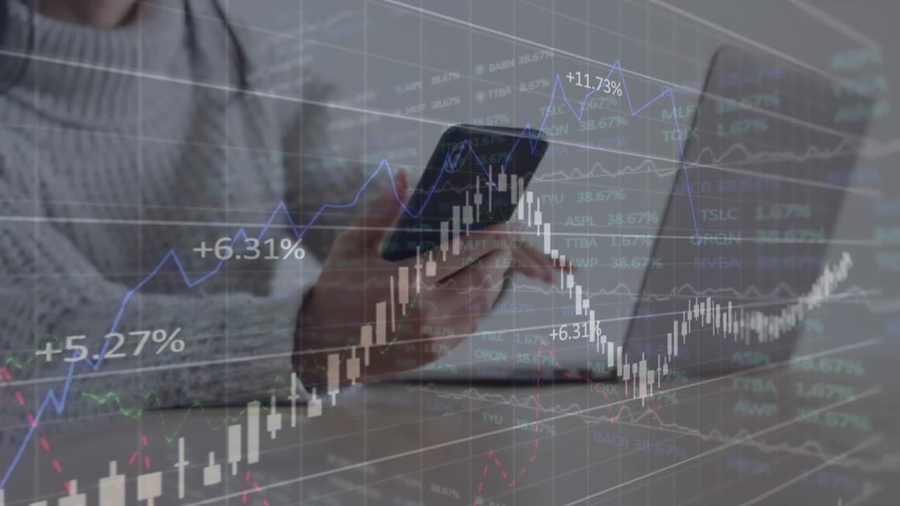 Woman using phone and laptop, tapping phone making finance charts showing percent rise for trading