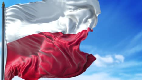 polish flag is waving slowly against blue sky