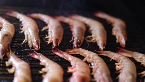 sequential grilling of shrimp over open flames