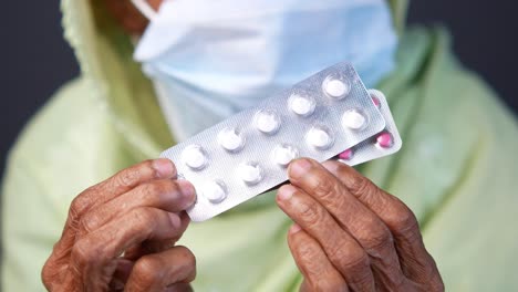 elderly woman holding medicine