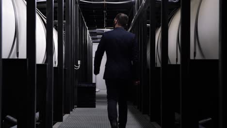 businessman walking through an industrial facility