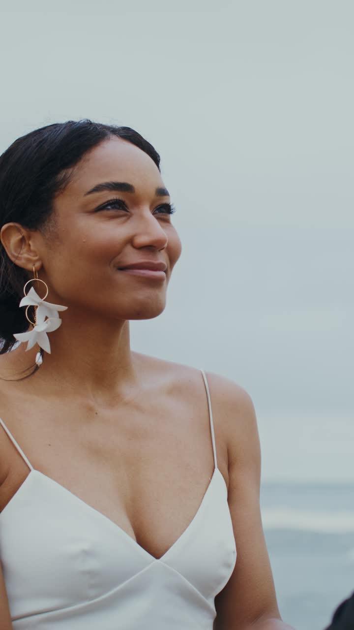Elegant woman in white dress at the beach
