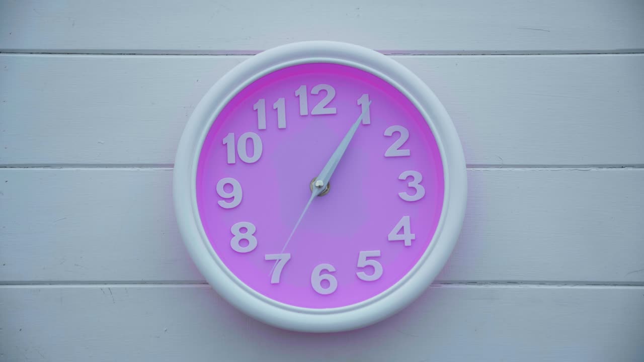 Time laps wall pink clock move quickly. Time is running out