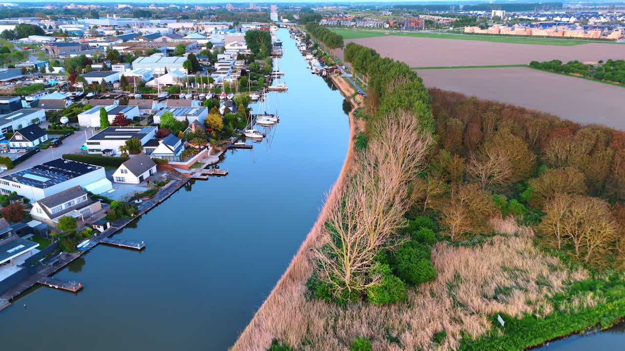 Blue sky reflecting in the smooth waterscape of the canal. Aerial perspective on Vinkeveen, the Netherlands.