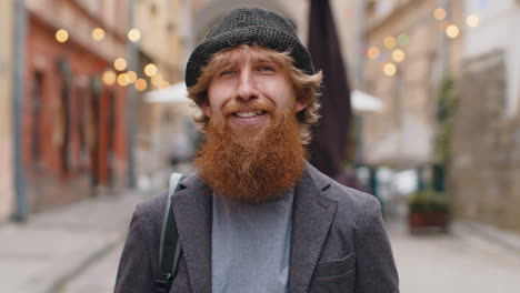 Happy young man smiling looking away dreaming resting good news feel satisfied in city street