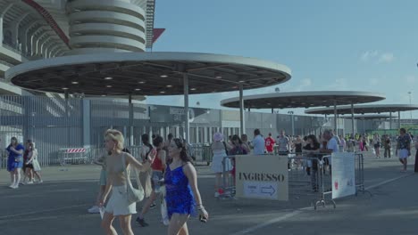 people gathering at an event stadium entrance gate