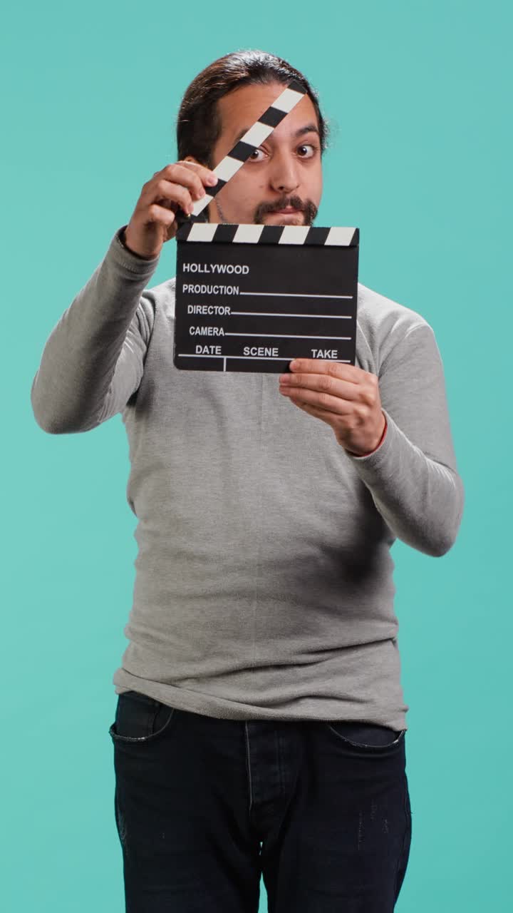 Vertical video Movie director using clapper on set, filming video production