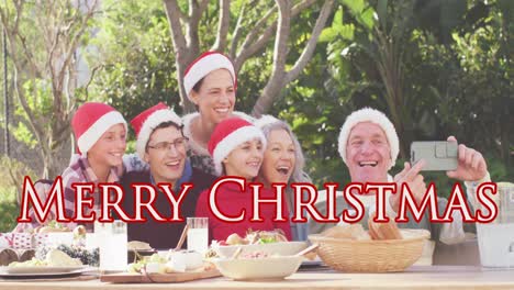 Animation-of-christmas-greetings-text-over-caucasian-family-in-santa-hats-at-christmas-table