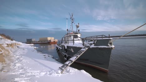 winter river scene with tugboat and barges