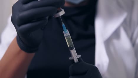 professional doctor in gloves and mask with medical syringe in hands, getting ready for injection 1