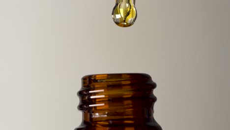 gold oil in retro rustic brown glass bottle dripping medication tincture homeopathy