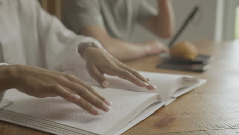 close up view of woman hands touching a book