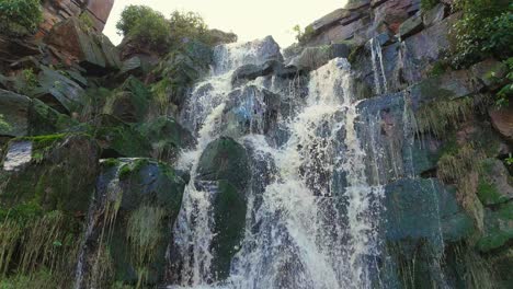 Aerial-drone-footage-of-a-tall-rocky-waterfall-in-the-Yorkshire-Dales,-Pennies