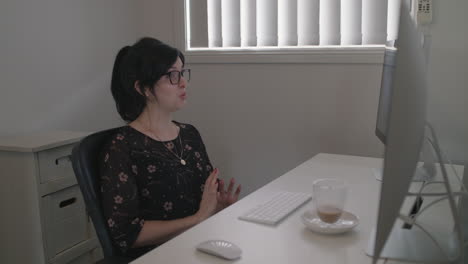 Woman-chatting-on-a-zoom-call-while-working-from-home