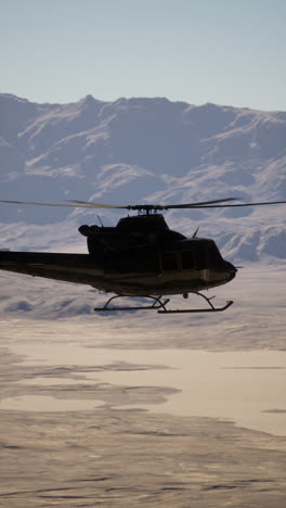 helicopter flying over mountains and desert