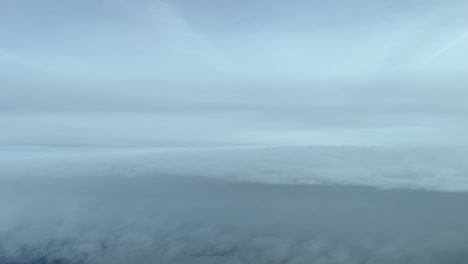 an awesome pilot’s perspective: flying through a sky full of snow clouds in a cold winter day, 12000m high