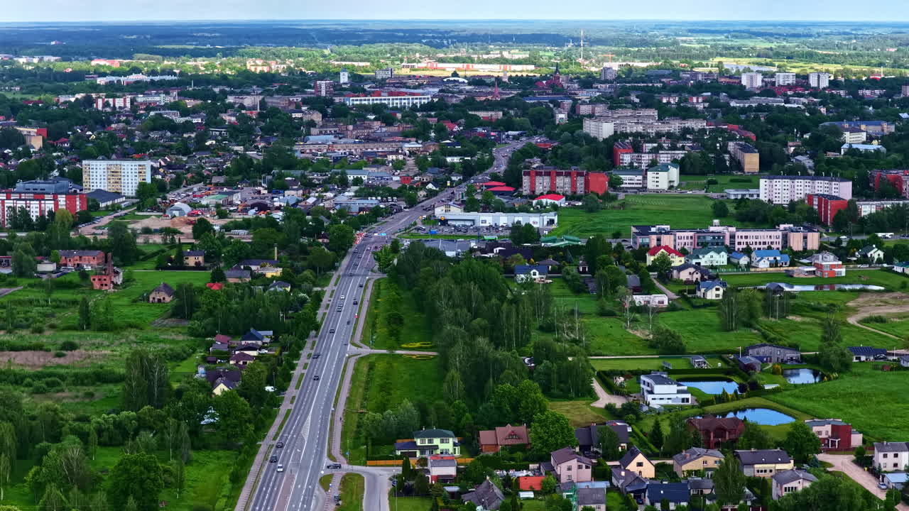 Urban cityscape with main highway leading into densely built residential and commercial areas