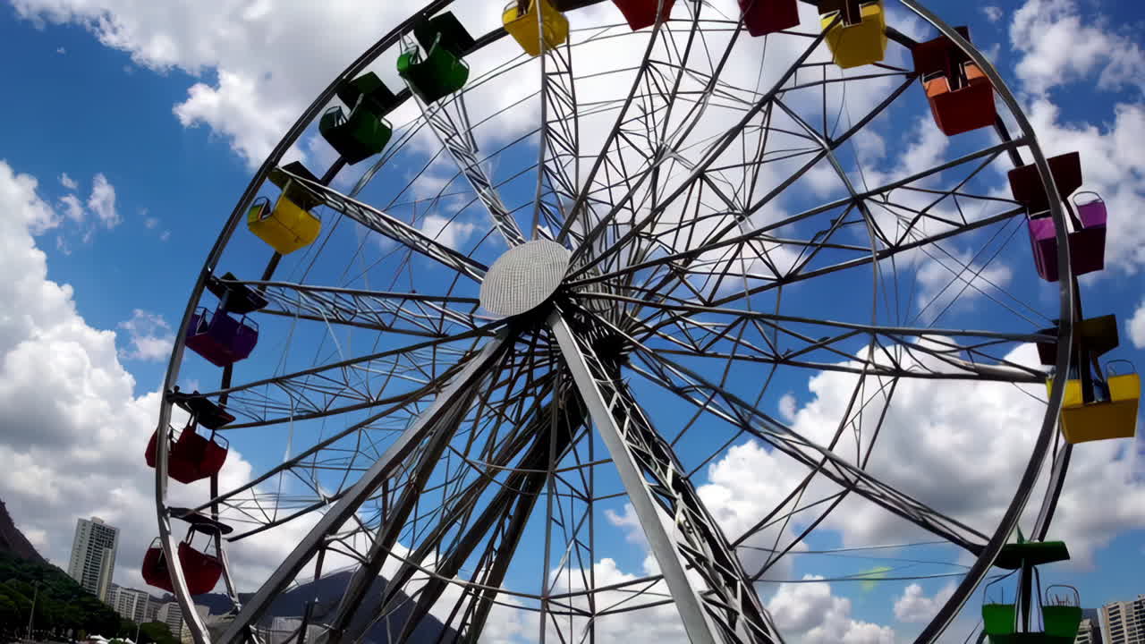 A vibrant Ferris wheel against a bright blue sky with clouds