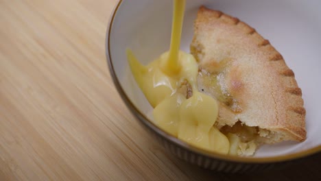 custard being poured into onto an apple pie