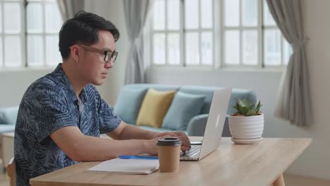 man work from home with laptop computer, video in 4k