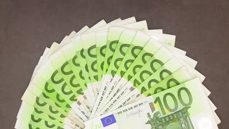 one hundred euro banknotes moving on dark background - stop motion