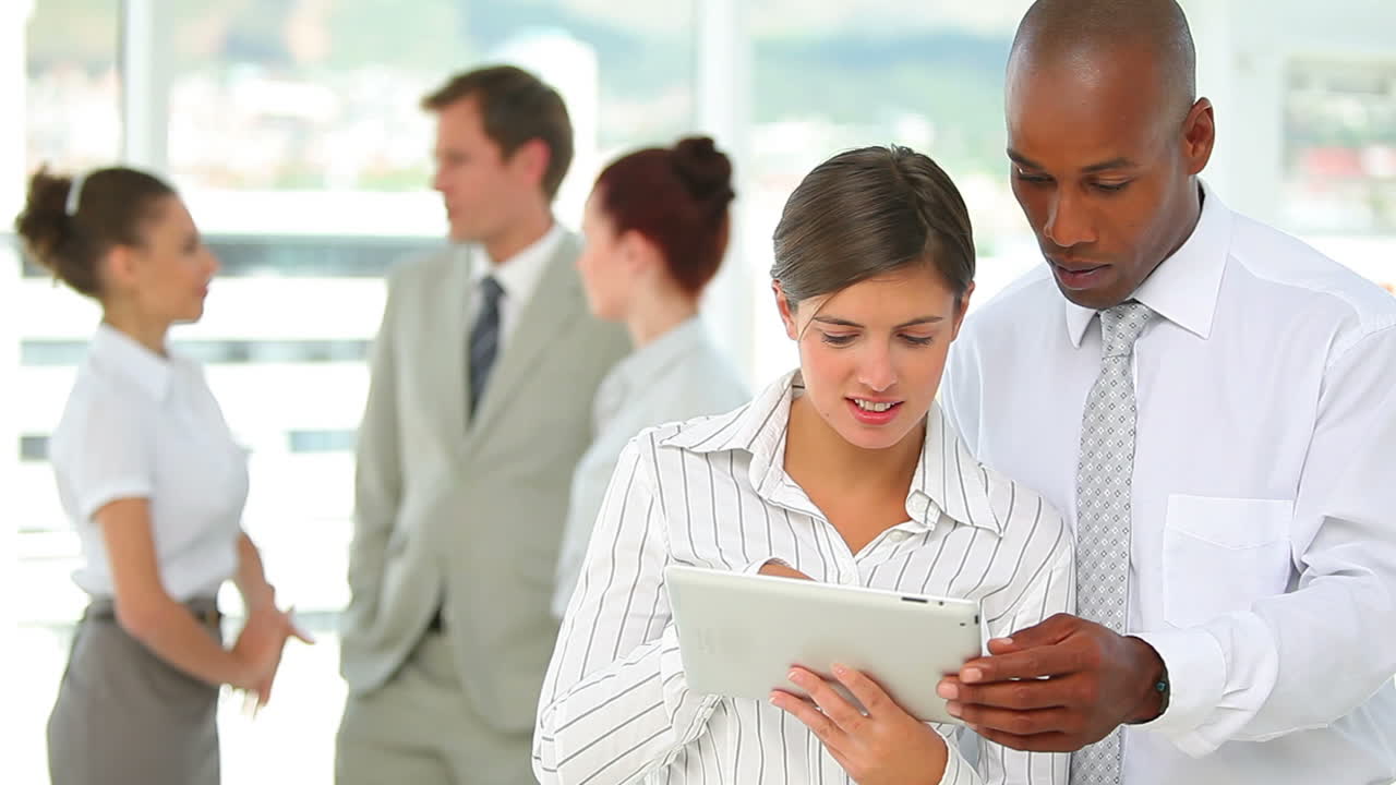 Two business people working together on a tablet