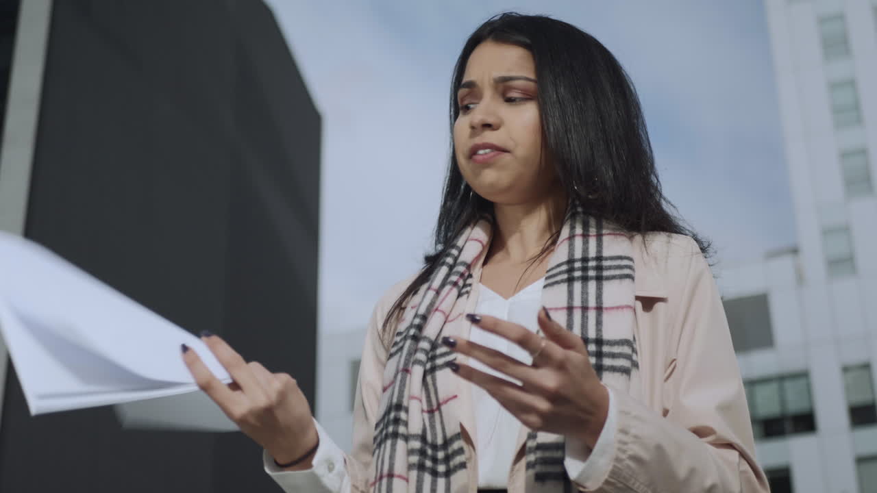 Businesswoman working with documents on street