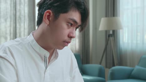 close up of asian man student using computer to study online at home
