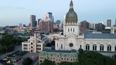 aerial view of saint marys chatedral with minneapolis skyline in the background during blue hour