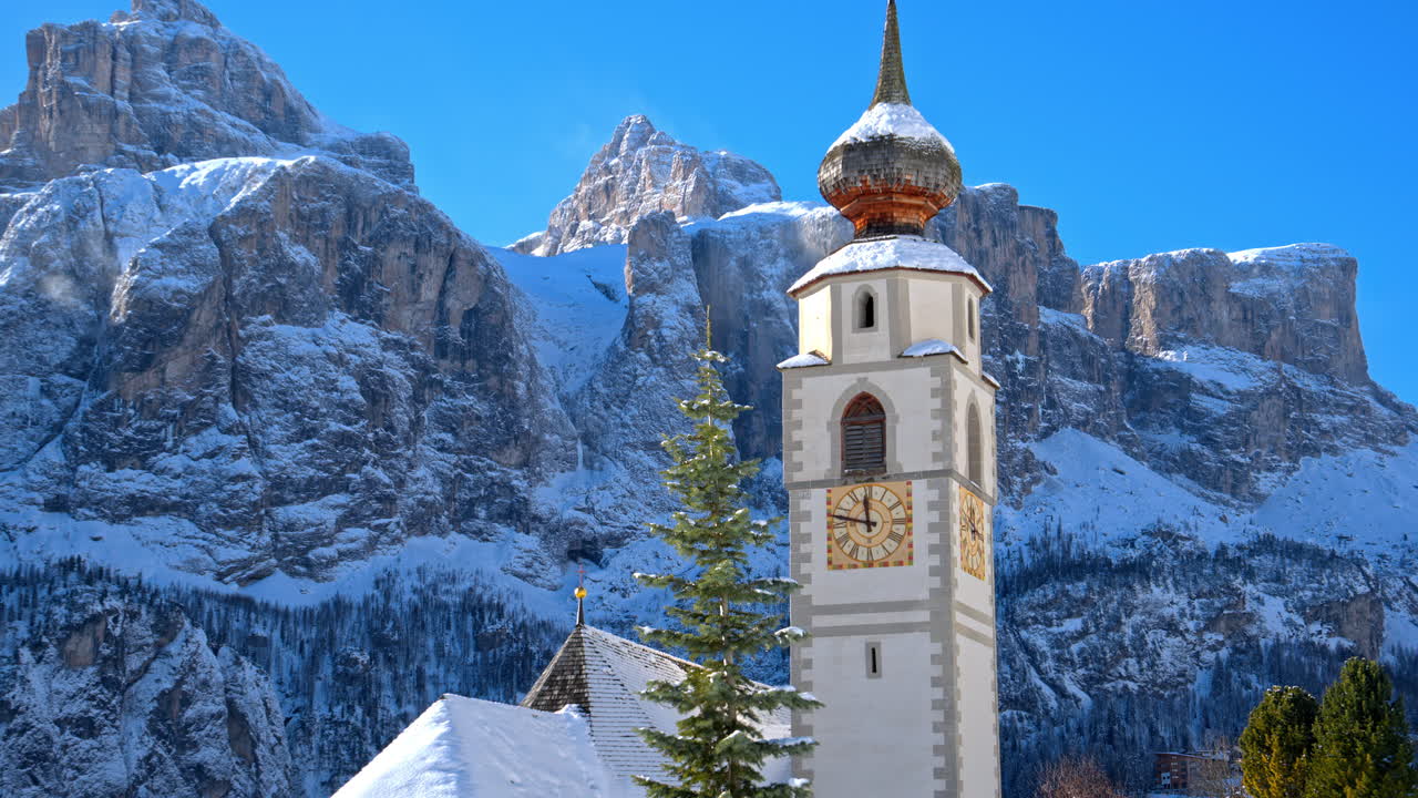 Close up of the Parrocchia di Colfosco in the Colfosco mountain village covered in snow, in South Tyrol, Dolomites, Northern Italy