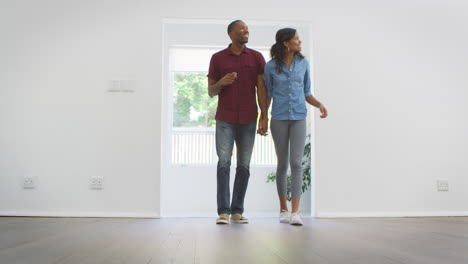 excited young couple moving into new home together