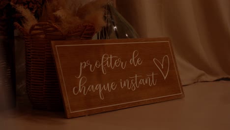 slow revealing shot of an enjoy every moment sign at a wedding