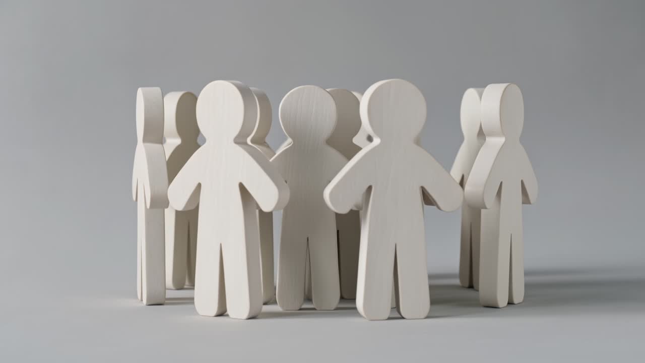 Group of wooden peg dolls standing together in a circle formation