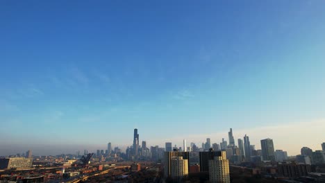 aerial drone of city of chicago skyline morning sun and blue sky