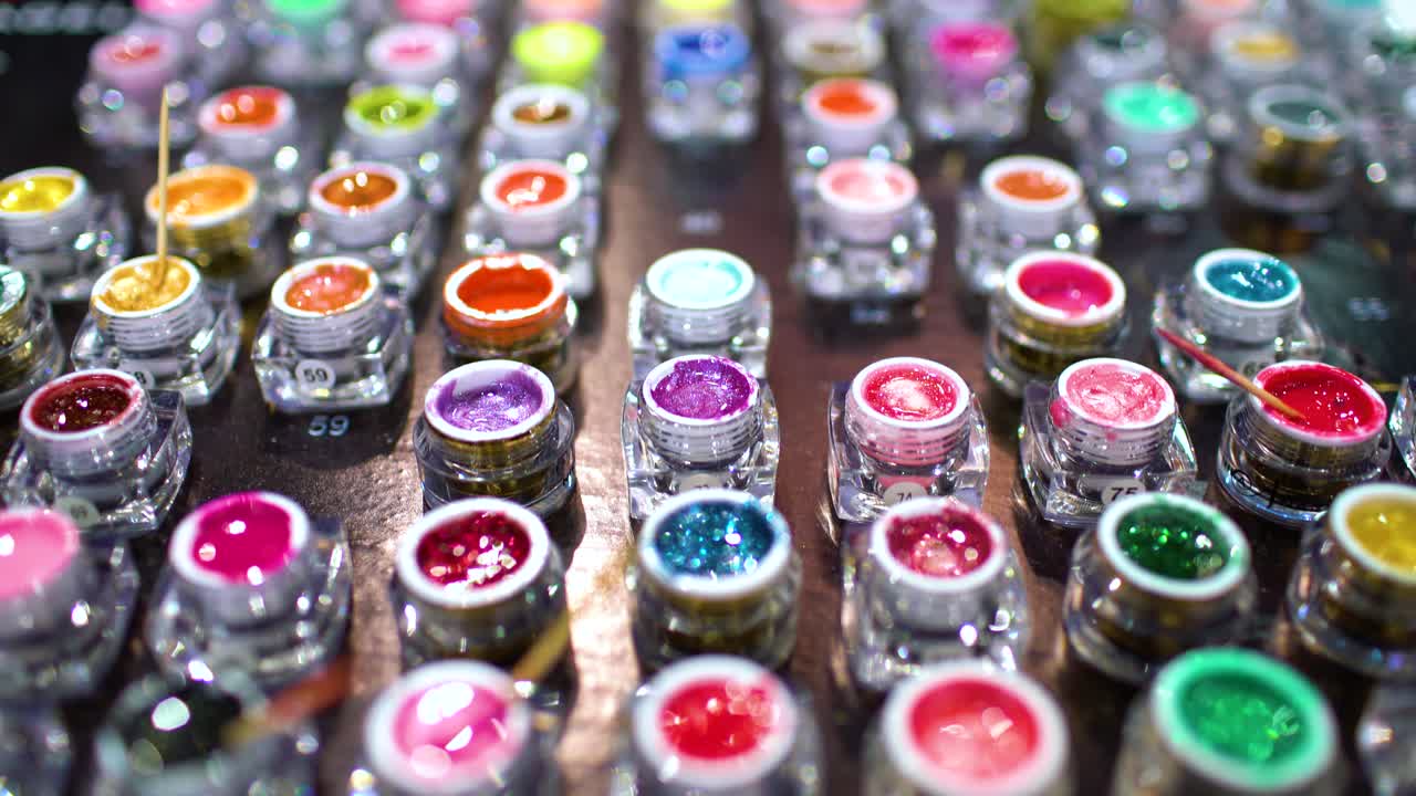 Сollection of acrylic powder different colors for nails closeup. Shallow depth of field