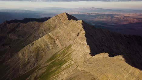 morning golden hour light contrasting on the side of mt nebo in salt lake city utah - aerial drop tilt