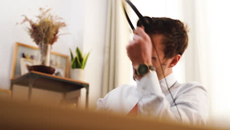 Caucasian-businessman-in-necktie-suit-working-remotely-in-video-conference-throw-headphone-after-a-long-exhausting-day-of-hard-work-in-the-office