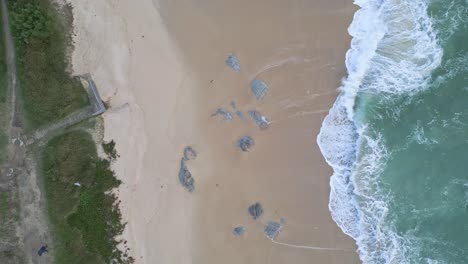 Empty-white-sand-beach-with-breaking-waves-in-Cangas,-Galicia,-Spain