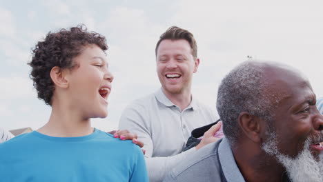 Portrait-Of-Smiling-Multi-Generation-Mixed-Race-Family-In-Garden-At-Home