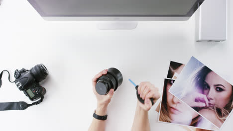 top view photographer cleaning lens working at desk from above - red epic dragon